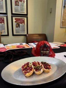 A photo of a fire helmet and food prepared by resident students during a Friends Cooking Safety program at BCSMU.