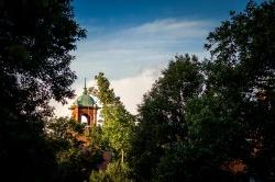 Campus bell tower surrounded by green trees