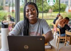 Montclair student studying on laptop at coffee shop